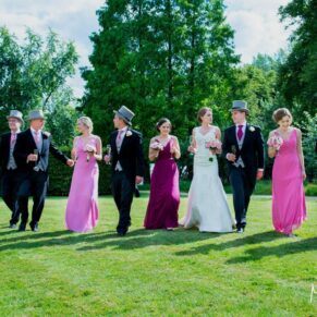 The bridal party walk across the lawns towards my camera in this relaxed capture