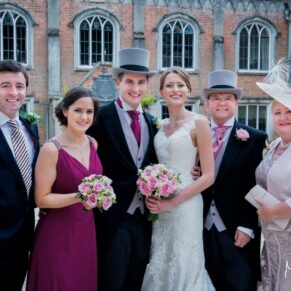 Family group pose in the historic courtyard of this historic property