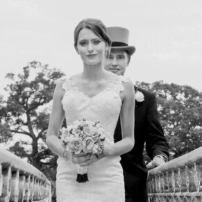 The newlyweds crossing the bridge and looking at the camera for this dramatic black and white pose