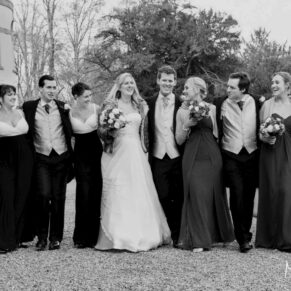Buckinghamshire Winter Wedding Photography - the bridal party walk arm in arm along a pathway at Hampden House