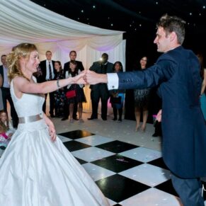 The newlyweds upping the tempo for their first dance in the marquee at their lively evening wedding reception