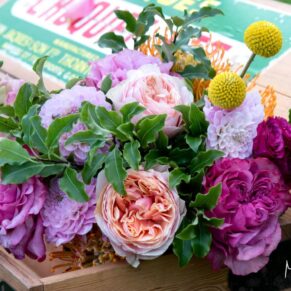 Vibrant bride's bouquet captured on the wooden croquet box during the drinks reception at this gorgeous summer wedding at Chenies Manor