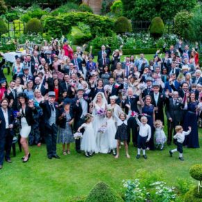 Big group shot from above capturing everyone in the stunningly beautiful gardens at this Hertfordshire venue - Chenies Mano