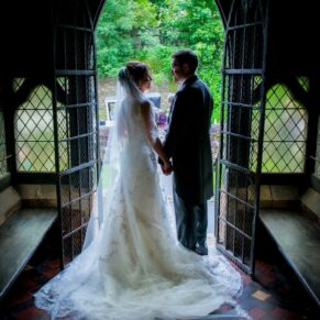 Silhouette photography of the newlyweds captured in silhouette at the parish church doorway at Clearwell soon after their ceremony
