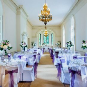 Photography of the sumptuous formal interiors inside Clearwell Castle's grand dining room all set for the wedding breakfast