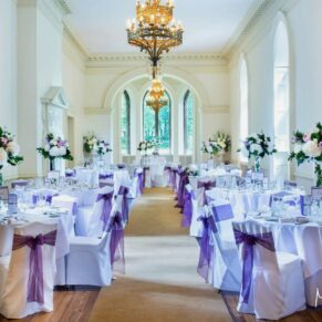 Photography of the grand high ceiling dining room all setup for the wedding breakfast at Clearwell Castle