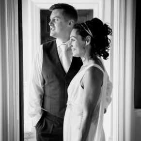 Dramatic black and white window lit portrait of the newlyweds at their Cliveden House wedding