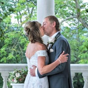 The first wedding day kiss captured during the outdoor summer ceremony at Cliveden House
