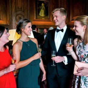 Guests enjoying lively conversation in the bar at this Cliveden House wedding