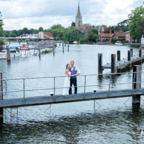 Dramatic view of the newlyweds with fabulous river views and the town seen off in the distance