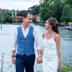The newlyweds take a stroll beside the river with Marlow town off in the distance