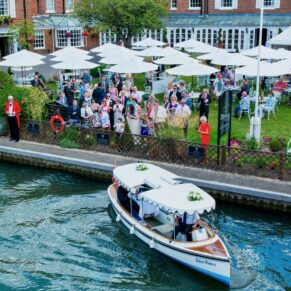 The boat departs from the hotel with the newlyweds onboard for their romantic short getaway from The Compleat Angler Hotel wedding reception
