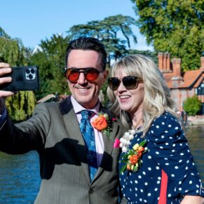 Selfie photography time beside the River Thames for these smiling wedding guests at The Compleat Angler in Marlow