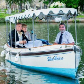 The newlyweds boat returns from their romantic river trip at their summer wedding at Marlow's Compleat Angler Hotel