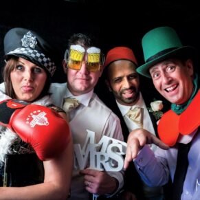 A photo-booth pose of some fun loving guests at this evening wedding reception at Danesfield House Hotel