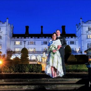 Dramatic night shot of the wedding newlyweds captured with my atmospheric floodlighting at the rear of Danesfield House Hotel