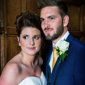 The newlyweds pose for a window lit portrait at their Dorton House wedding