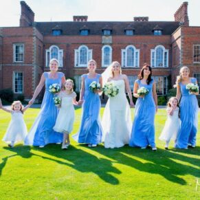 The bride and her entourage walk away from the venue at this Dorton House summer wedding reception