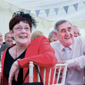 Guest reactions during the speeches at this lively Dorton House marquee wedding reception