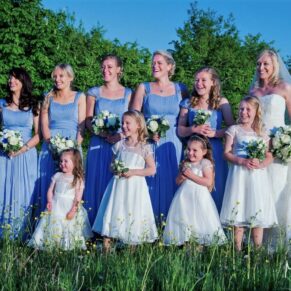 The ladies all gather for photo in the tall grass meadow at this gorgeous Dorton House summer wedding