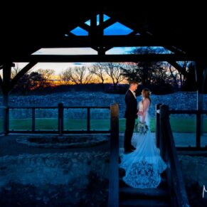 The newlyweds captured with low evening sunlight in one of the ancient doorways at this historic wedding venue