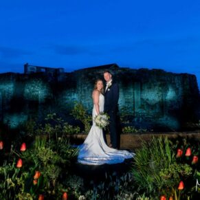I do love a challenge when it comes to night-time photos. This image would be totally black apart from the dusky sky it it wasn't for my floodlighting being used to illuminate this vast property. The newlyweds were always up for the challenge after I proposed this shot at our pre wedding meeting at Farnham Castle the month before. It takes a bit of effort, but a dramatic pose like this is a fabulous way to conclude the wedding photographs for the day! The bride and groom in front of the floodlit historic Farnham Castle at dusk on their wedding day