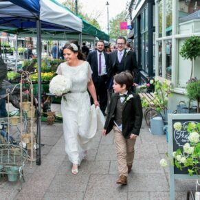 Gatsby Berkhamsted - Hertfordshire Wedding Photographer - the bridal party walking through the market stalls in the High Street