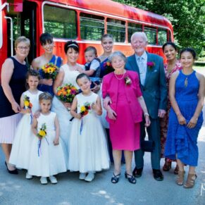 The bride's immediate family gather for a group pose after their bus journey from the church to their woodland reception venue