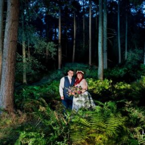 The newlyweds floodlit by my lighting in a magical woodland setting