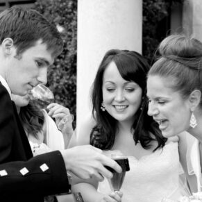 The bride enjoys some giggles with her friends during her drinks reception