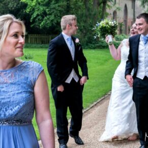 The newlyweds approaching the house with their best man and bridesmaid