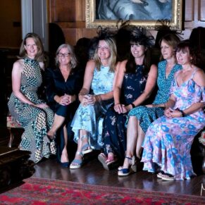 Casual group shot of some ladies giggling in the Great Hall whilst sitting on a large sofa