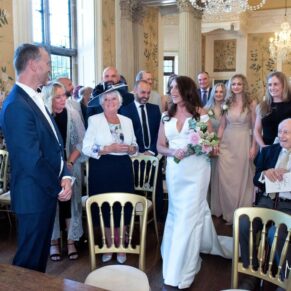 The entrance of the smiling bride for the indoor civil ceremony