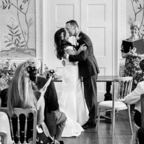 The first kiss for the bride and groom during the intimate indoor civil ceremony