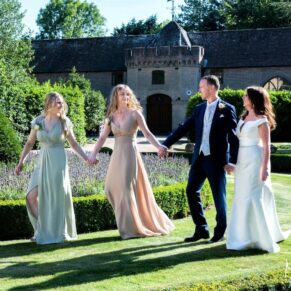 The newlyweds take a stroll with their bridesmaids at the front of their fabulous Chilterns reception venue