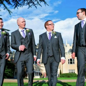 The lads take a leisurely stroll before the ceremony with the main house in the background