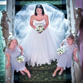 The bride with her bridesmaids captured dramatically from above on the grand staircase at Hartwell House