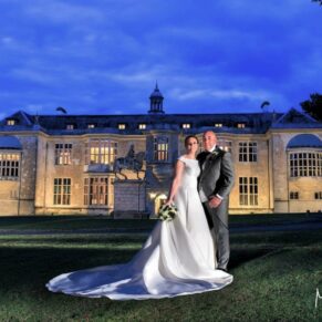 Striking dusk pose of the newlyweds captured under deep blue skies with my floodlighting at Hartwell House Hotel