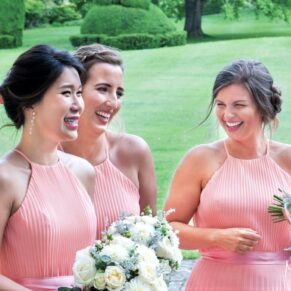 Three bridesmaids enjoying a giggle during the drinks reception at this Hartwell House summer wedding