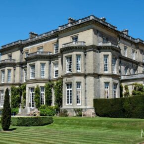 The grand facade of this famous Buckinghamshire wedding venue under perfect blue skies