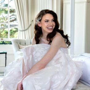 The bride captured adjusting her shoes before her ceremony in the grand bridal suite at her Hedsor House wedding