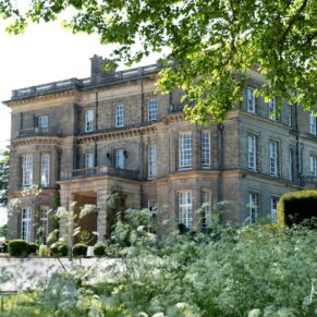 Hedsor House captured through the stunning floral landscape on a summer's wedding day