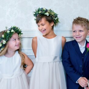 Candid moment from the page boy and flower girls as they relax before the wedding ceremony in the bridal suite