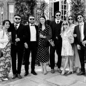 A black and white pose of some guests on the terrace during this Hedsor drinks wedding receptionn