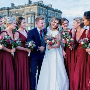 The newlyweds with their bridesmaids captured informally with Hedsor House as the backdrop for this autumnal wedding