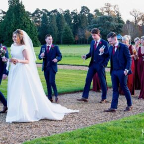 The newlyweds and their bridal party take a relaxed stroll in the gardens at Hedsor House in Buckinghamshire