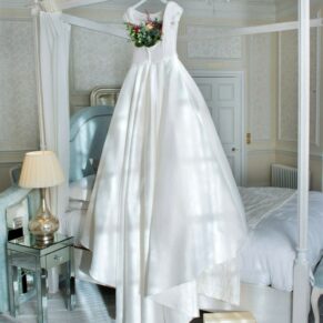 This stunning gown was hung from the four poster for this striking image in the bridal suite at Hedsor
