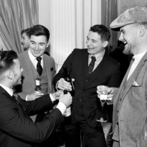 Lively guest banter in the bar at this Hedsor House wedding