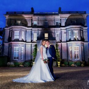 The newlyweds strike a pose at dusk outside this grand Buckinghamshire venue - the dusky blue skies have created a magical fairy tale look for this capture