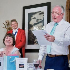 Dad's lively wedding speech in progress as he's watched by an appreciative audience